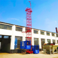 Fix one column and two cages with a construction material elevator on the construction site. Safety of construction elevators for preventing falling, single occupancy, and double cages