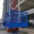 Fix one column and two cages with a construction material elevator on the construction site. Safety of construction elevators for preventing falling, single occupancy, and double cages