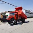 A brand new four wheel tractor with 25 horsepower and a four wheel truck for pulling wood agricultural transport