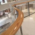 Solid wood stairs against the wall, beech wood handrails, corridor safety railings, wooden handrails, shopping mall atrium handrails