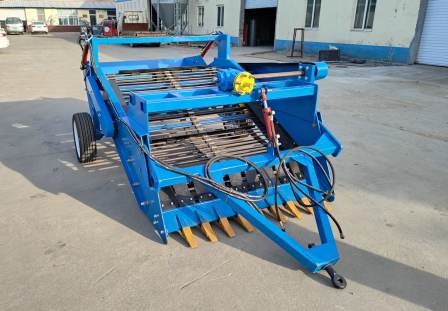 Four wheeled tractor with agricultural stone picker, automatic small stone screener for land reclamation, agricultural gravel collector