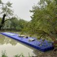 Aquatic aquaculture net cage yacht docks at a floating plastic movable dock on the sea