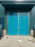 Colored steel sandwich panel doors can be equipped with small doors and windows for good insulation. Large workshops use industrial swing doors in Deshun